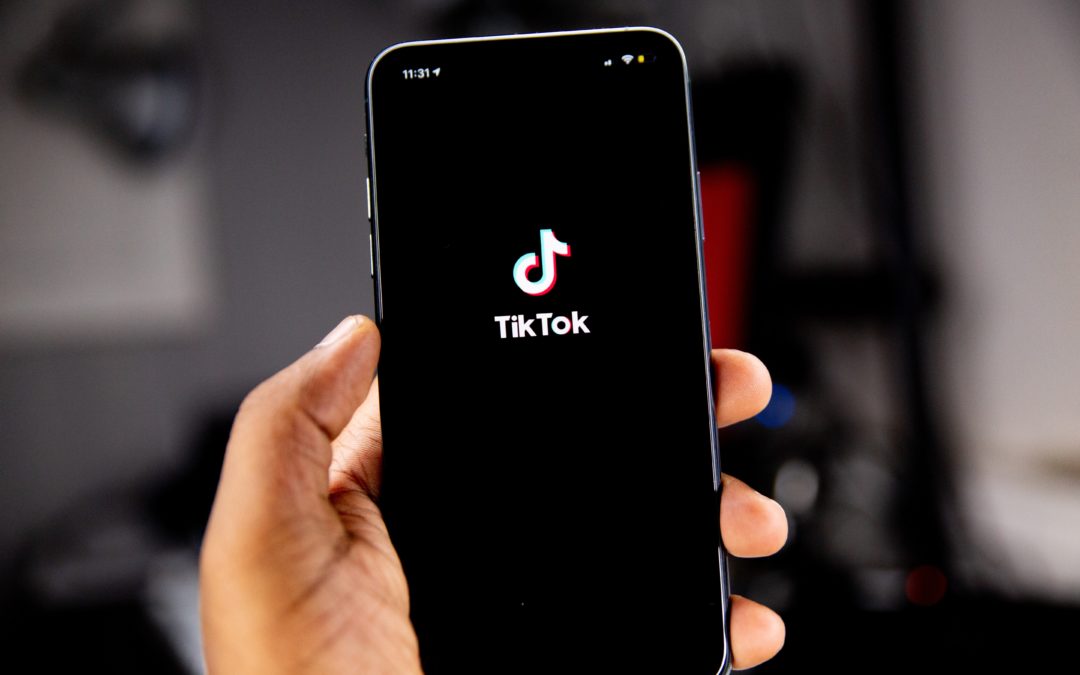 Person holding a phone with Tiktok open