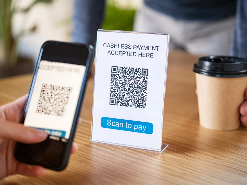 Someone paying via QR code on phone