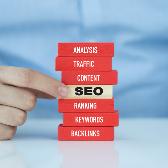 Red jenga blocks with the words Analysis, Traffic, Content, SEO, Ranking, Keywords and Backlinks